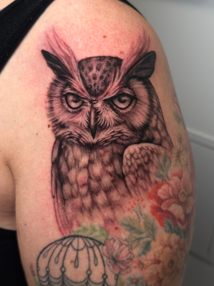 Realistic owl tattoo with pink details